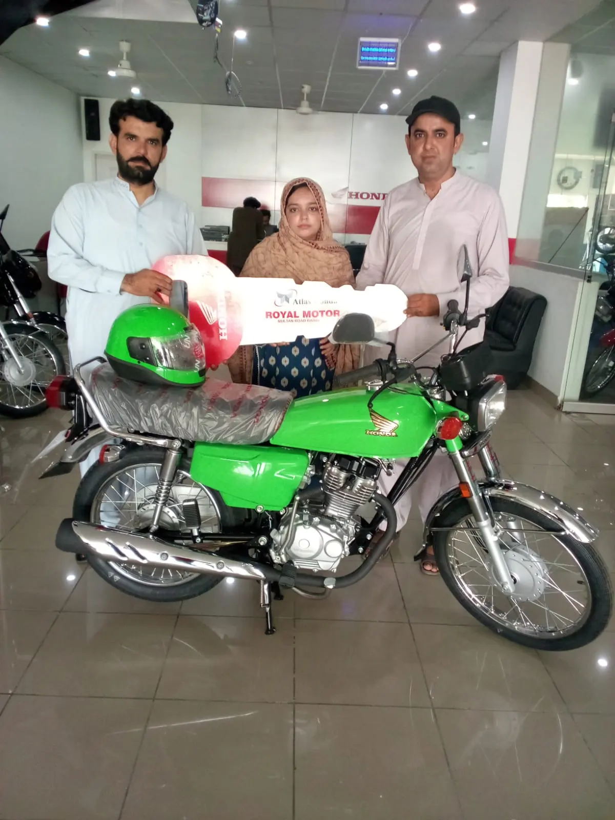 A successful applicant taking delivery of his scheme bike