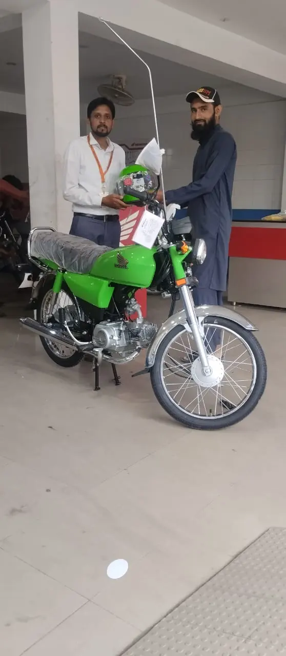 A helmeted beneficiary ready to ride his new scheme bike home