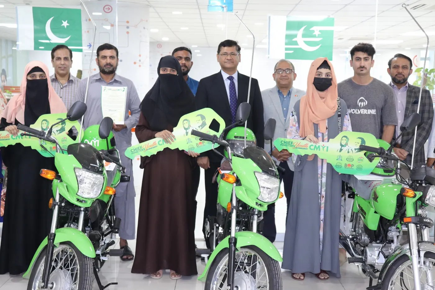 Scheme beneficiaries with their new bikes outside the dealership