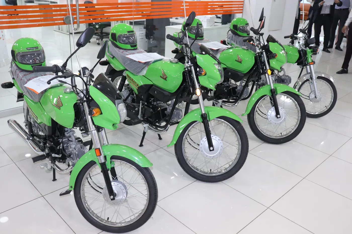 Dealership staff completing delivery documentation for scheme bikes