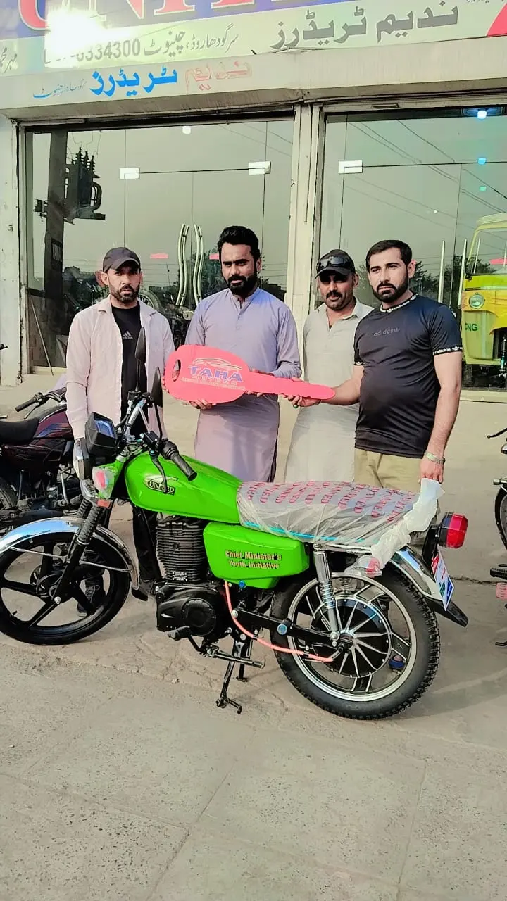 A student beneficiary riding away on his new electric bike from the distribution ceremony