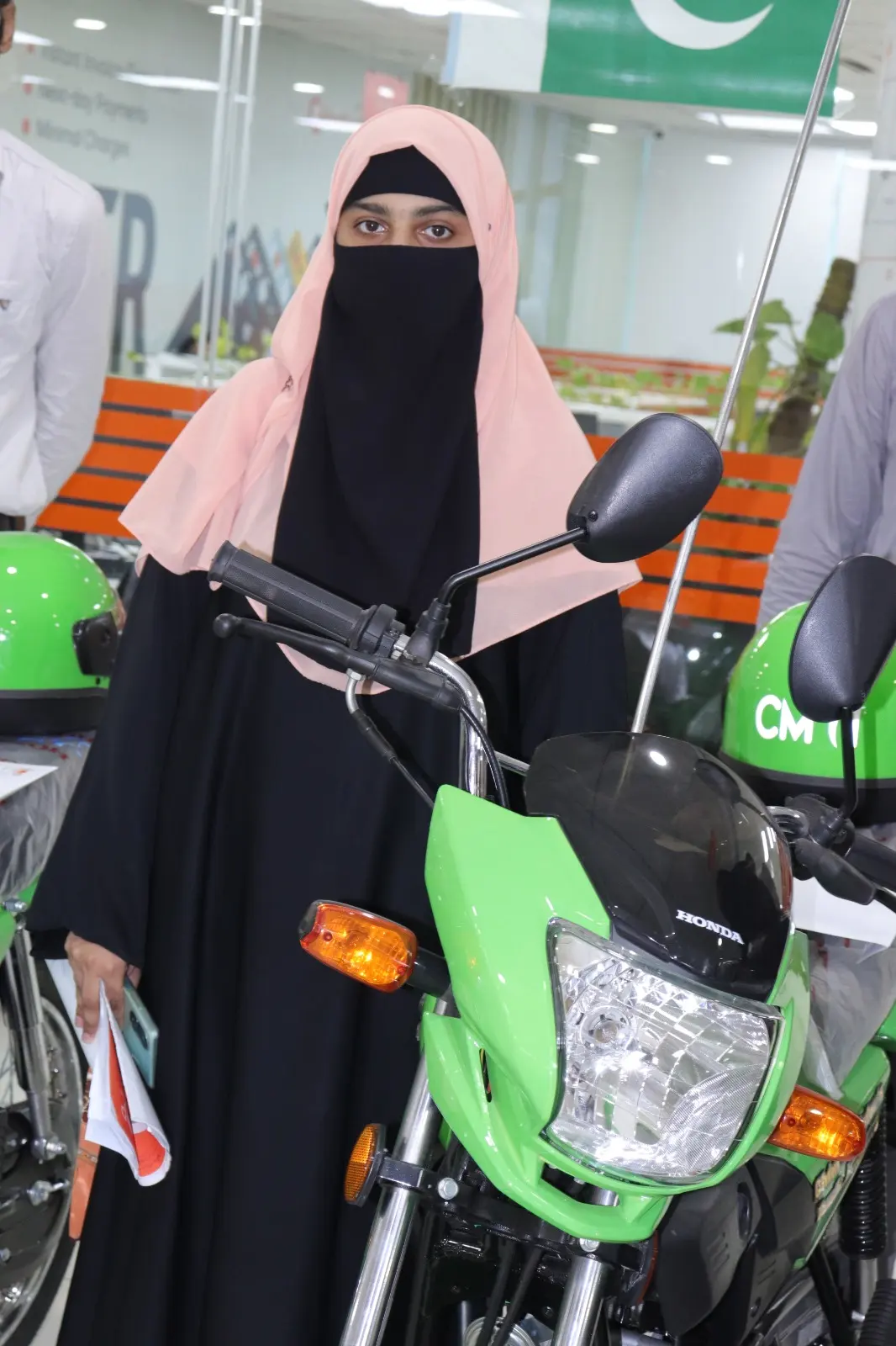 Beneficiaries celebrating with their new scheme bikes after completing financing formalities